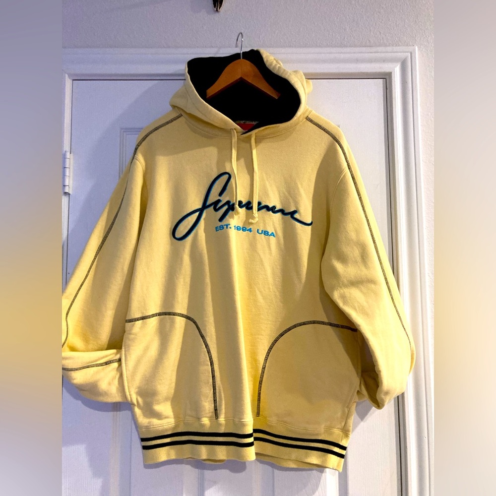 Yellow and blue hooded supreme sweatshirt.